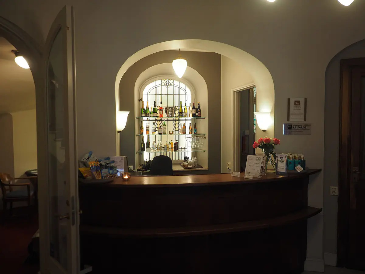 A hotel reception desk in a lobby