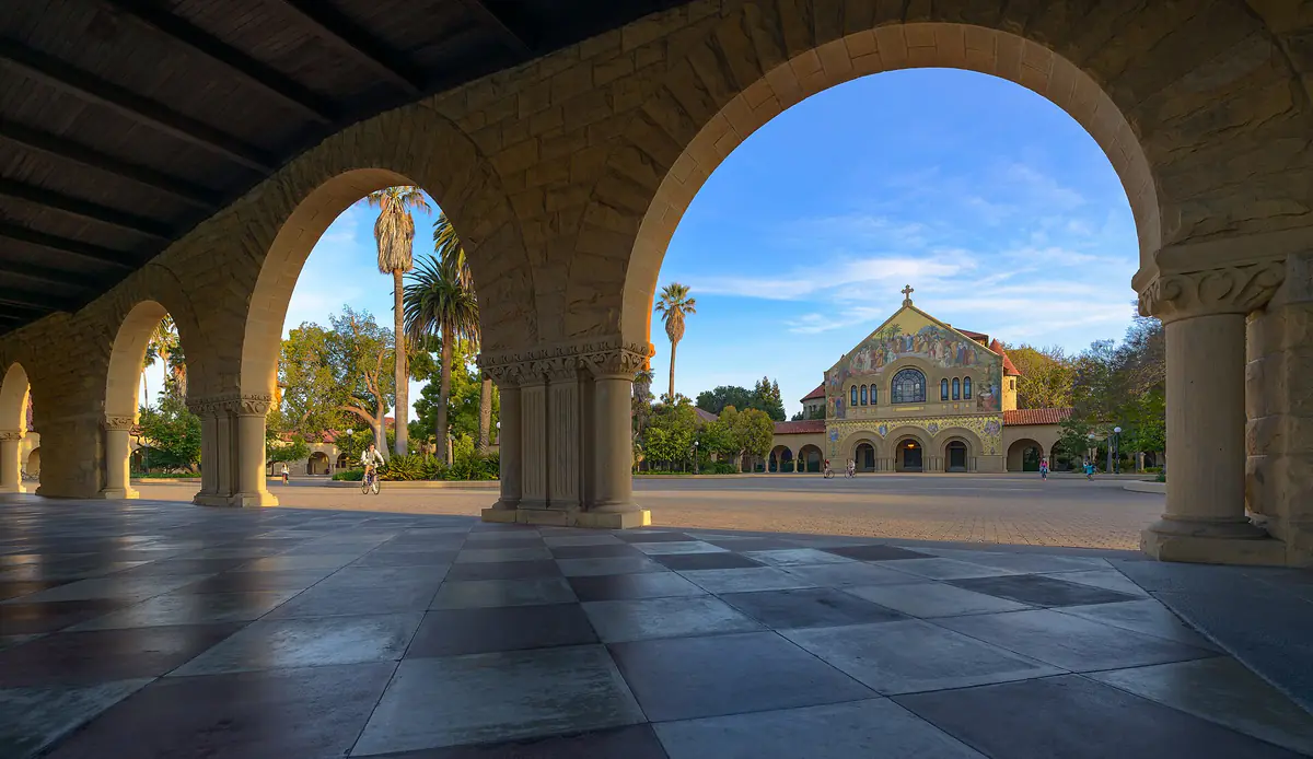 Stone arches at Stanford University with Memorial Church in the background