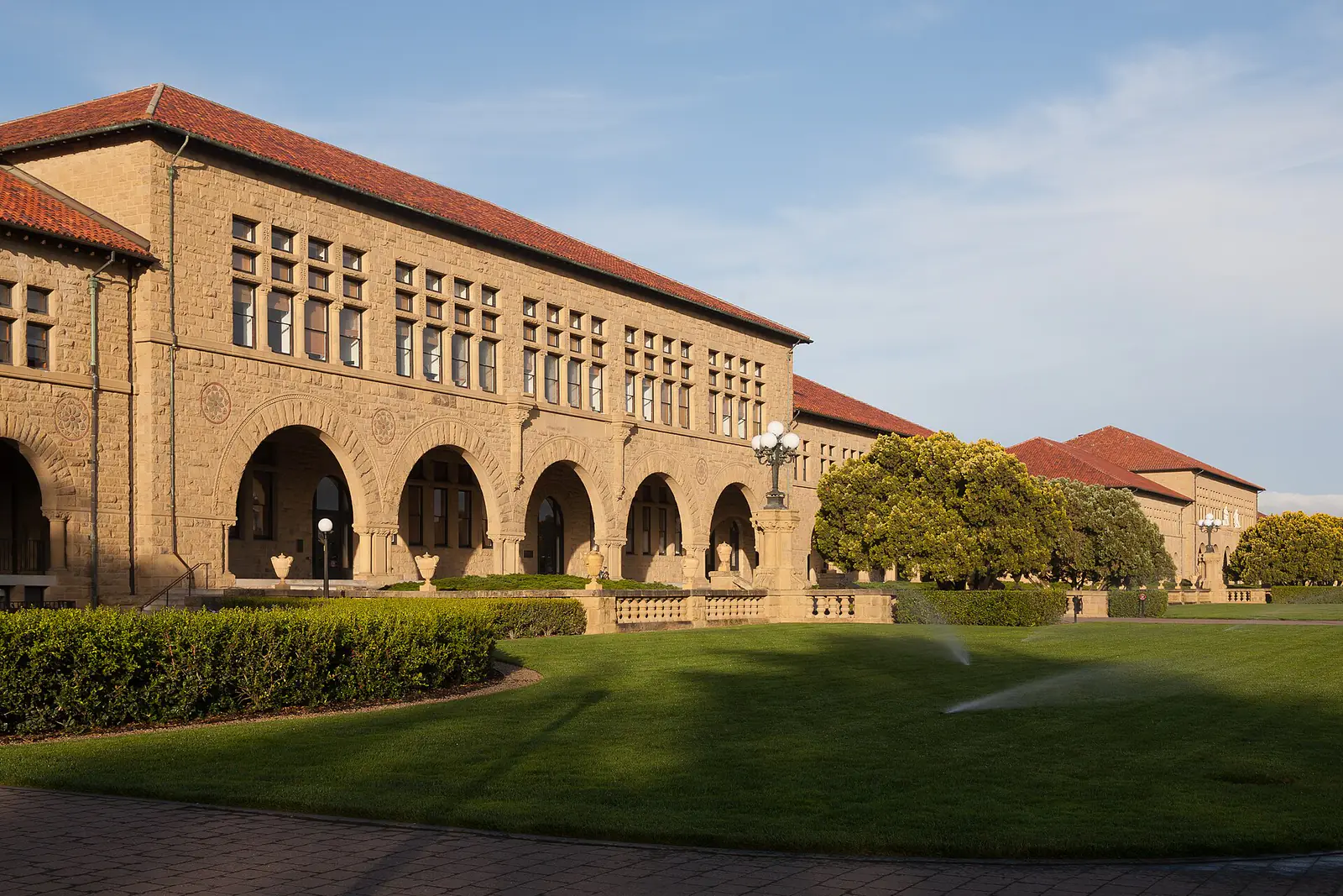 The sandstone arcades of the Main Quad at Stanford University on a sunny day
