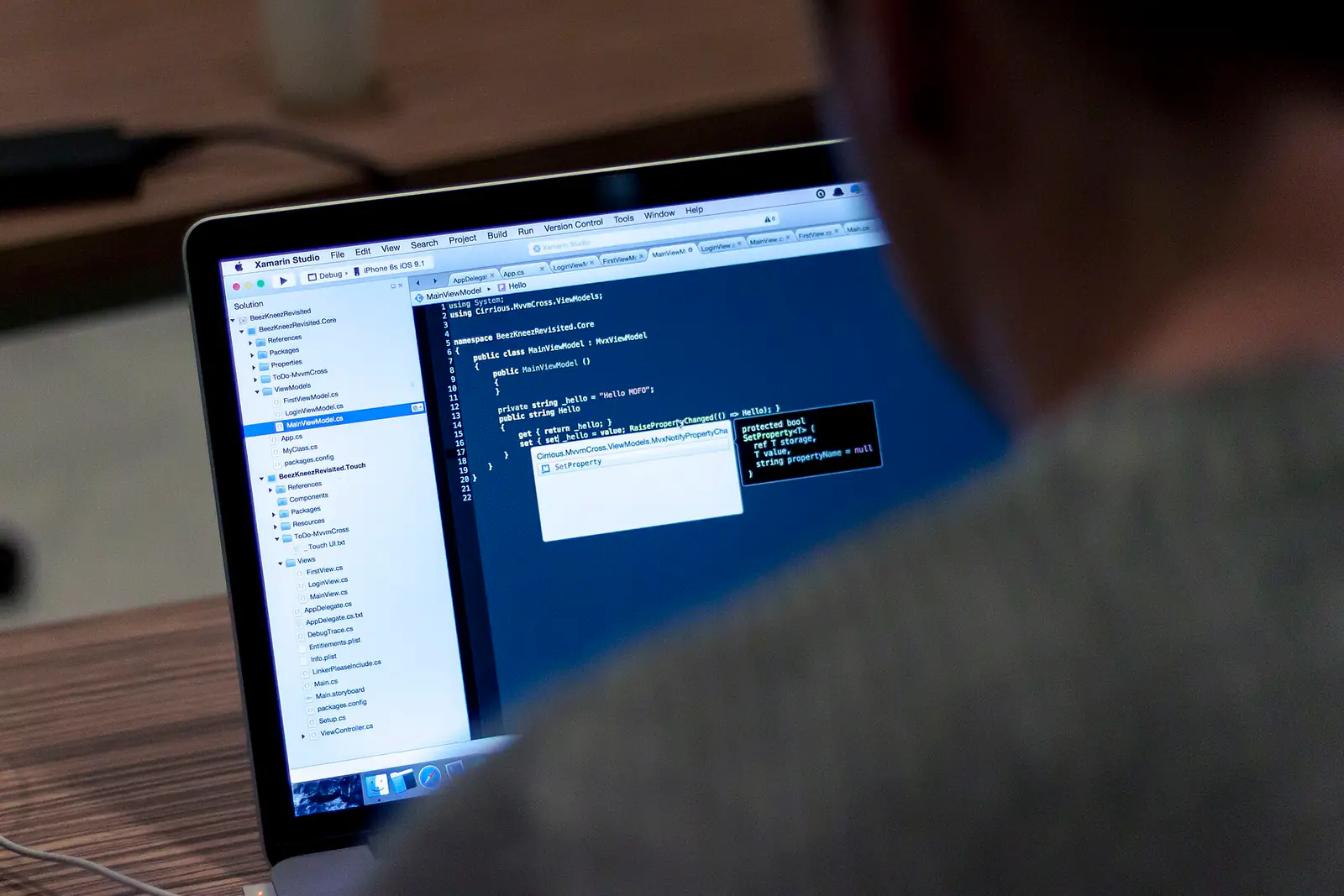 A laptop on a desk showing code