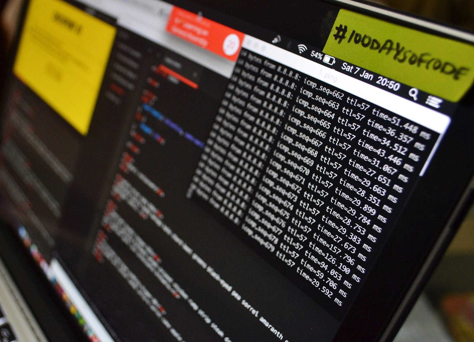A laptop screen with a code editor, a terminal and a #100DaysOfCode sticker