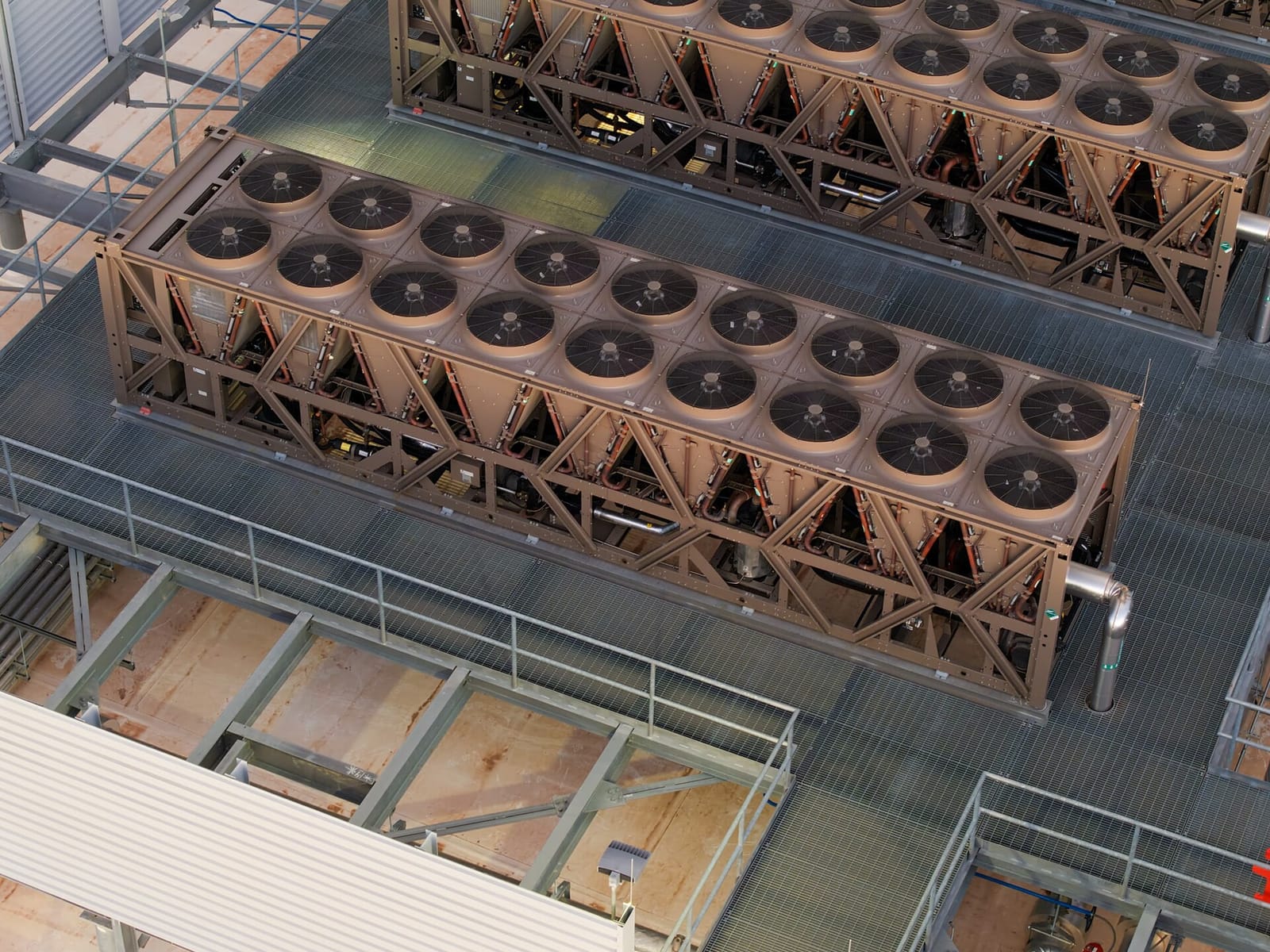 Rows of fan-driven cooling units on the roof of a data center